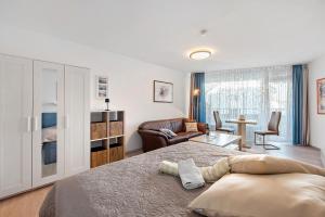 a bedroom with a bed and a living room at Fewo Jutta in Oberuhldingen +29 photos