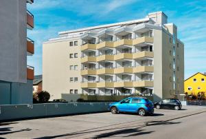 a blue car parked in front of a building at Fewo Jutta in Oberuhldingen