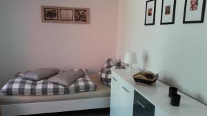 a bedroom with a bed and a white desk at Ferienwohnung am Malchiner See mit Boot und Kanu in Seedorf +15 photos