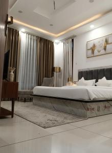 a bedroom with a large bed in a room at Chatnya Homes Kasauli by Splendid Hotels - Family Groups Events in Kasauli