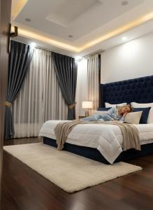 a woman laying on a bed in a bedroom at Chatnya Homes Kasauli by Splendid Hotels - Family Groups Events in Kasauli +11 photos