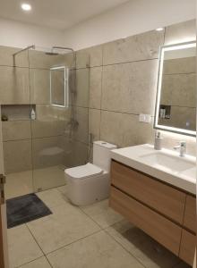 a bathroom with a toilet and a sink and a shower at Chatnya Homes Kasauli by Splendid Hotels - Family Groups Events in Kasauli