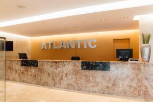 an office lobby with a atlantic sign on the wall at Moon Dreams Atlantic in Es Cana +18 photos