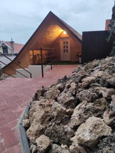 a large pile of rocks in front of a house at Némó Apartman in Eger