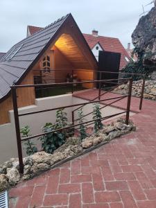 a small house with a roof on a brick driveway at Némó Apartman in Eger +42 photos