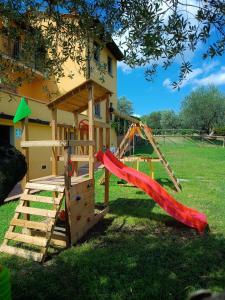 a play house with a slide and a slide at Agriturismo Il Pintello in San Casciano in Val di Pesa
