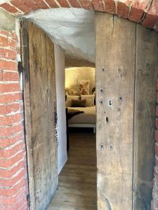 an open door into a room with a bedroom at Le Cocon Secret in Saint-Cyr