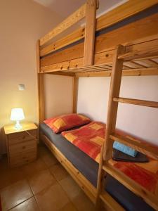 a bedroom with two bunk beds and a lamp at Apartments and Rooms With View on Bled in Bled