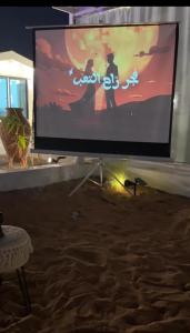 a large screen with a video game on it at Deem view in Al Ain