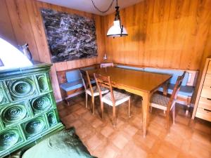 a dining room with a wooden table and chairs at Chalet Genziana in Cavalese