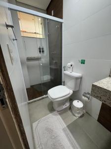 a bathroom with a toilet and a glass shower at Alzira Plaza Hotel in São Lourenço +92 photos
