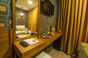 a hotel room with a desk and a mirror at Kuzen Otel in Istanbul +47 photos