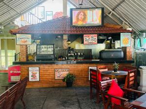a restaurant with a bar with a tv on top at Hill Cool Hotel & Restaurant in Hatton
