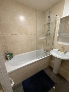 a bathroom with a bath tub and a sink at A&A Luxury Stay Rosedale - 4 Bed Residence in Sunderland +9 photos