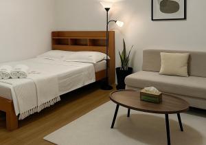 a bedroom with a bed and a table and a couch at Balai de Biday 4 Pax Suite with Free Breakfast in Mameltac