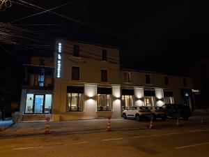 a building with a car parked in front of it at night at Casa La Fayette in Timişoara