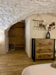 a bedroom with a wooden door and a dresser at Le Cocon Secret in Saint-Cyr +4 photos