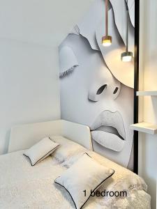 a bedroom with a bed with a painting on the wall at Boutique Higueron Spa in Fuengirola