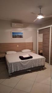 a bedroom with a bed and a ceiling fan at Hotel vitoria in Pedreira