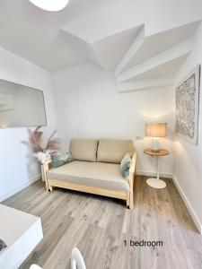 a living room with a couch and a table at Boutique Higueron Spa in Fuengirola +89 photos