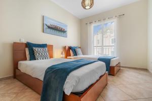 a bedroom with two beds and a window at Sunny Ponta "Nomads' village" in Ponta do Sol
