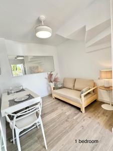 a living room with a couch and a table at Boutique Higueron Spa in Fuengirola