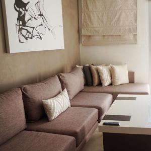 フニデクにあるHotel Honorのリビングルーム(枕付きのブラウンソファ付)