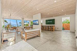 a living room with a table and chairs and the ocean at One Palm in South Cocoa Beach