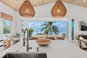 a kitchen with a sink and a view of the ocean at One Palm in South Cocoa Beach +94 photos