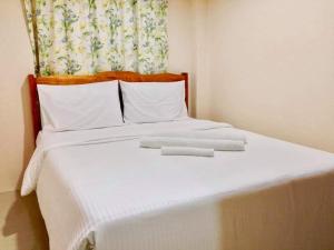 Ένα ή περισσότερα κρεβάτια σε δωμάτιο στο Dumaguete Suites