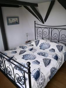 a bed with a black and white comforter at De WitteZwaan in Harlingen