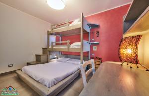 a bedroom with two bunk beds and a table at Sunset Apartment with Air Conditioning and Lake View in Perledo