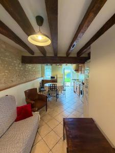a living room with a couch and a table at Gîte la Nobleterie - Zoo de Beauval 35 min in Frédillé