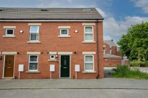 a red brick house with a green door at Oxheys Stays - Sleeps 7 - Home from Home in Preston