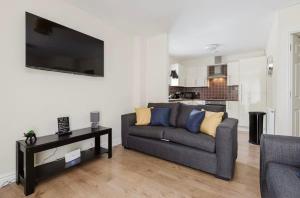 a living room with a couch and a table at Oxheys Stays - Sleeps 7 - Home from Home in Preston