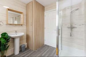 a bathroom with a shower and a sink and a mirror at Oxheys Stays - Sleeps 7 - Home from Home in Preston +23 photos