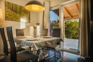 a dining room with a table and chairs and a window at Casa Lutoma in Kmeti