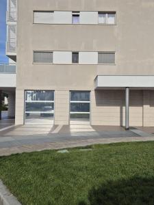 a building with a grass field in front of it at mirosa airport home in Macchie