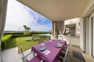 a table with a purple table cloth on a patio at Vivere il Parco in Lonato