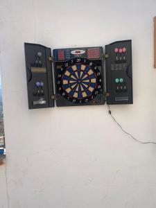 a dart board on a wall with two controllers at Natura Escapade Guesthouse in Torrox