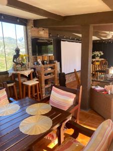 a living room with a wooden table and chairs at Natura Escapade Guesthouse in Torrox