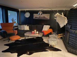 a living room with a couch and a table with candles at Lapland Riverside Home in Rovaniemi