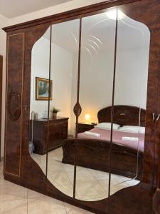 a bedroom with a bed in a glass enclosure at B&B Altea in Pescara