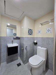 a bathroom with a toilet and a sink at Hotel Seri Putra in Kuala Lumpur