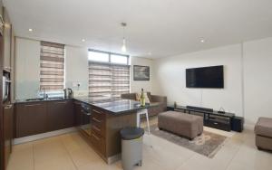 a kitchen with a large island in a room at Neat Apartment at Eden on the Bay in Big Bay