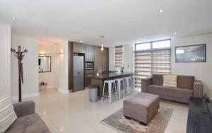 a living room with a couch and a kitchen at Neat Apartment at Eden on the Bay in Big Bay