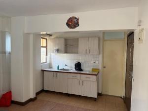 a kitchen with a sink and a counter top at Emeli Hotel Luxury Suites in Nairobi +3 photos