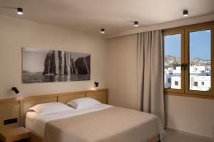 Postel nebo postele na pokoji v ubytování Portiani Suites