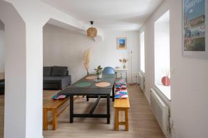 a living room with a table and a couch at Les Rives du Château, 90m2, vue sur le canal in Saverne