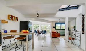 a kitchen and living room with a table and chairs at Villa Swahili1 in Les Avirons